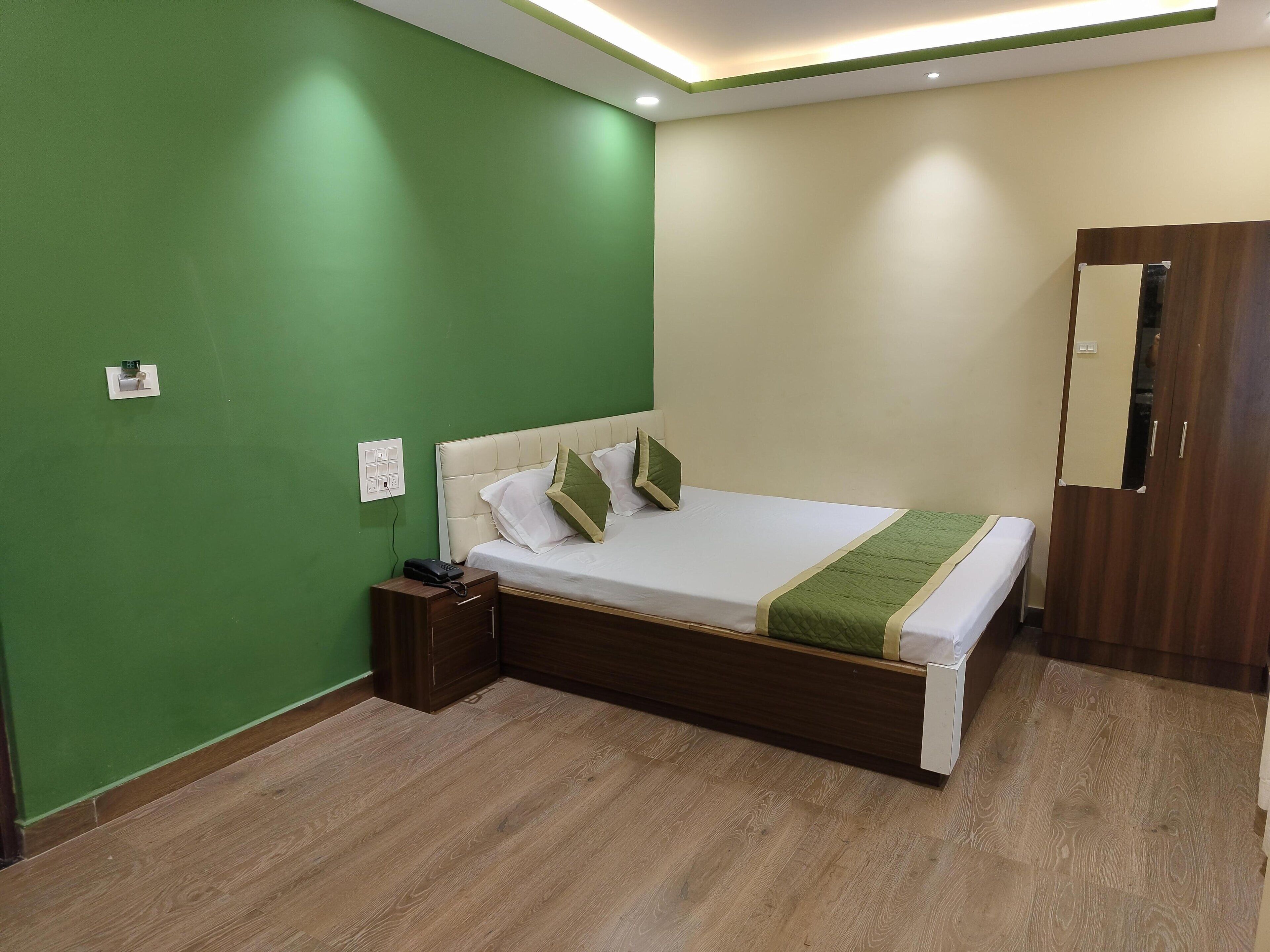 A neatly arranged bedroom with a bed, bedside table, and a wardrobe.