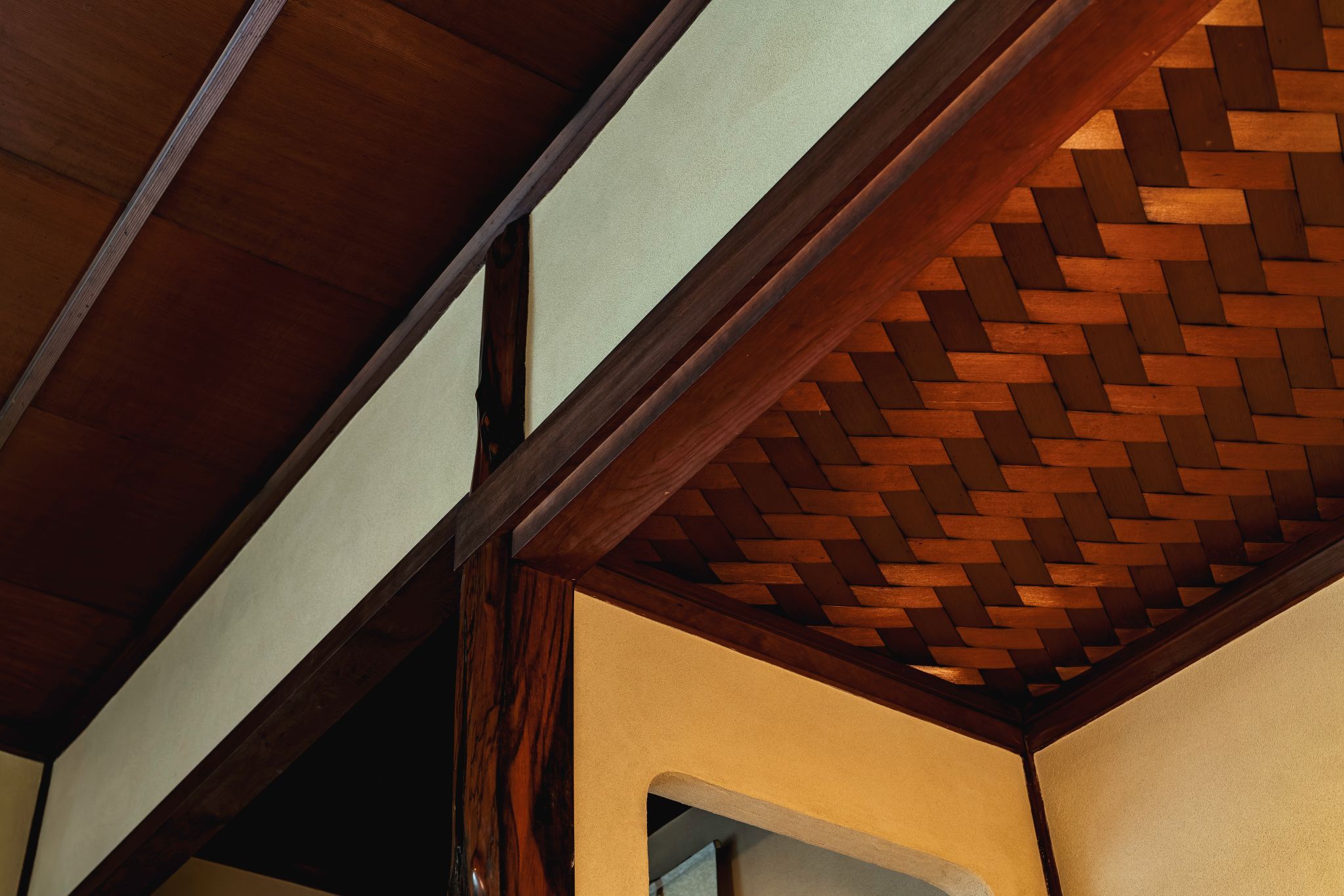 A wooden ceiling structure with a woven pattern.