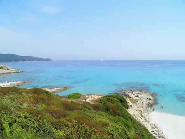A coastal landscape with clear turquoise waters, rocky shorelines, and a sandy beach. - SUPERB MEDITERRANEAN VILLA 12 Pers SEA VIEW & ST TROPEZ, close to BEACHES & GOLF (Grimaud)