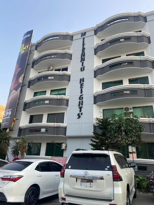 A multi-story building with a prominent sign reading 'MENU HEIGHTS.'