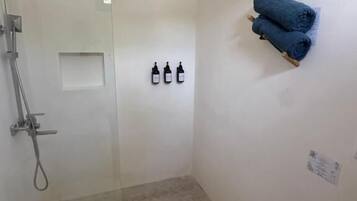 Quadruple Room, Patio, Garden View | Bathroom | Shower, hair dryer, towels, soap
