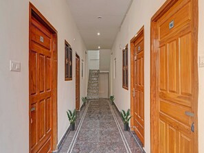 A hallway with wooden doors numbered 105 and 104, leading to a staircase.