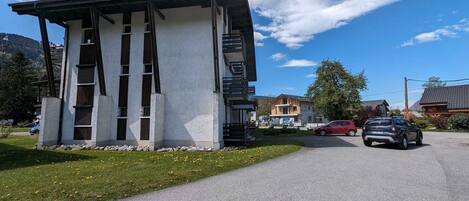 A modern building with a unique architectural design, featuring a sloped roof and a series of vertical supports.