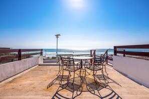 A rooftop terrace with a table and chairs, a railing, and a view of the ocean. - Bright Dog-friendly Suite With Kitchenette, Heated Outdoor Pool, Hot Tub, Patio (Playas de Rosarito)
