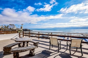 A terrace with a view of the ocean, equipped with outdoor furniture and a pool. - Dog-friendly Oceanfront Villa With Rooftop Patio, Pool Access, & Kitchen (Playas de Rosarito)