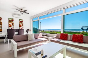 A modern living room with a sofa, coffee table, and artwork on the walls. - Serene Dog-friendly Villa With Impressive Views, Outdoor Pool, Private Patio, AC (Playas de Rosarito)