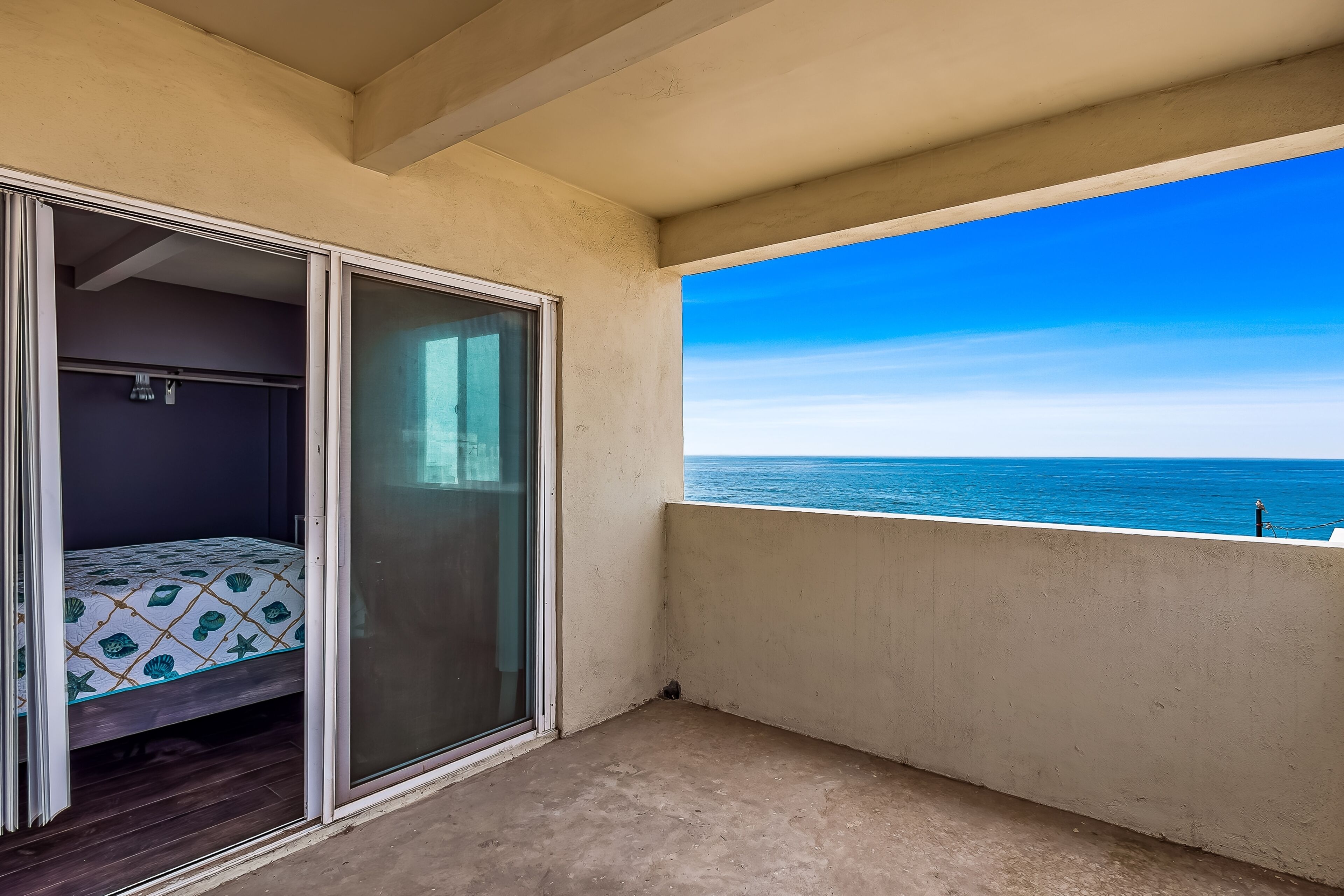 A balcony with a view of the ocean.