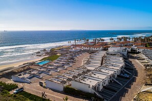 A coastal hotel with multiple buildings, a swimming pool, and a beach view. - Dog-friendly Home With Partial Ocean View, Heated Pool, Rooftop Terrace (Playas de Rosarito)