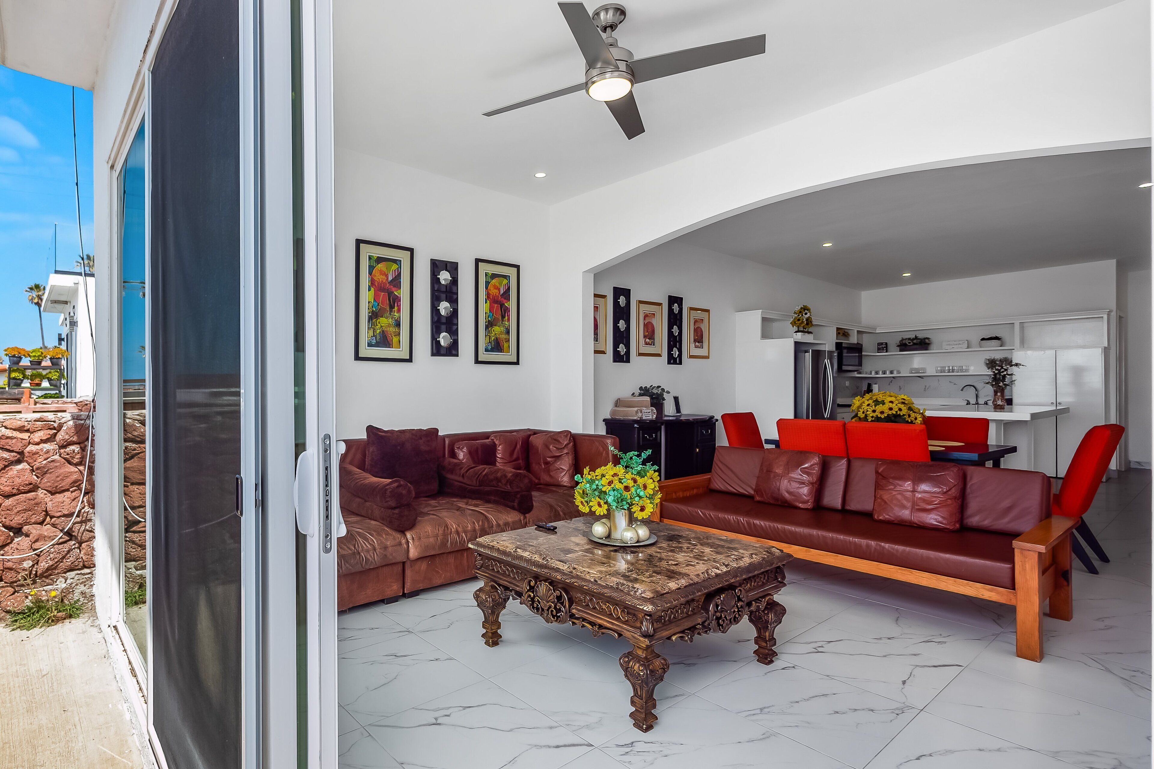 A modern living room with a sofa, coffee table, and artwork on the walls.