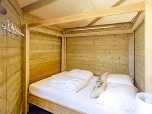 A wooden cabin-style room with a single bed, white linens, and a wooden ceiling. - Beachside Dune Home Retreat for 4 (Almere)