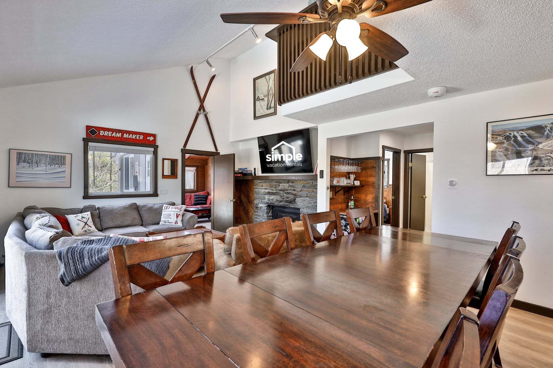 A spacious living area with a fireplace, a dining table, and a sofa.