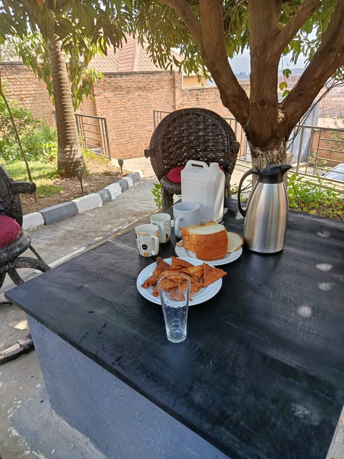 A picnic setup with a table, food, and drinkware.