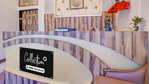 A reception desk with a sign reading 'Collection OYO-Serviced'. - Classic Collection O Kurla BKC Mumbai (Mumbai)