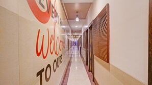 A hotel corridor with a 'Welcome to our' sign, a tiled floor, and a ceiling with recessed lighting. - Classic Collection O Kurla BKC Mumbai (Mumbai)