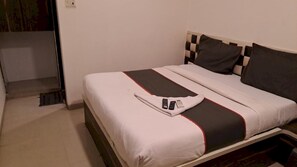 A hotel room with a bed, a nightstand, and a window. - Classic Collection O Kurla BKC Mumbai (Mumbai)