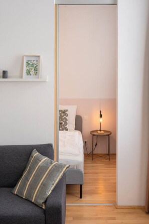 Ein modernes Schlafzimmer mit Bett, Nachttisch und Lampe.