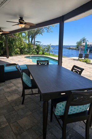 Outdoor dining - Backyard Bliss - Coastal Waterfront Pool Home with Amazing View of Peace River (Port Charlotte)