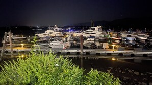 A marina at night with boats docked, a dock in the foreground, and a mountain in the background. - Superb Mid Hudson Valley Newburgh for relaxing stays North of U S ARMY WEST PT. (Newburgh)