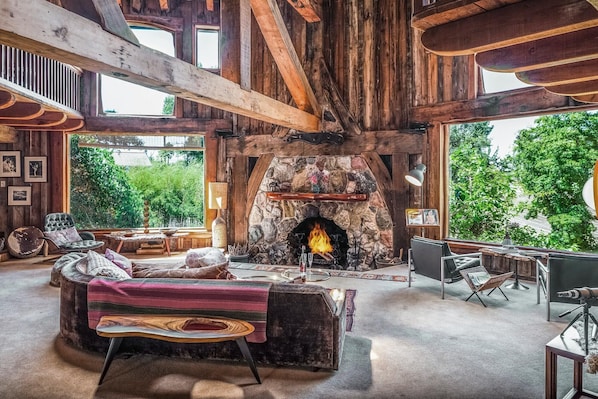 A rustic interior with a stone fireplace, wooden beams, and a cozy seating area. - Luxury Wine Country Estate Near Downtown/Wineries (Paso Robles)