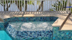 A swimming pool with mosaic tiles and a hot tub area. - Peaceful Newly Renovated Canal Home in Punta Gorda (Punta Gorda)