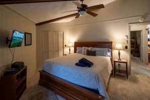 A bedroom with a bed, a ceiling fan, a television, and a desk with a printer. - Timber Ridge Sugar Mountain Condo. Sleeps 8. (Sugar Mountain)