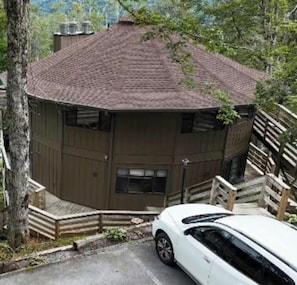 A multi-story building with a sloped roof, wooden exterior, and a staircase leading to the entrance. - Timber Ridge Sugar Mountain Condo. Sleeps 8. (Sugar Mountain)