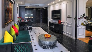 A modern living room with a sofa, a coffee table, and a TV.
