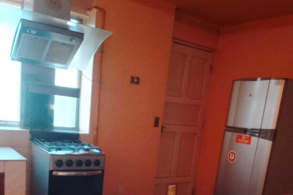A kitchen with a stove, oven, and refrigerator.