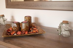 A wooden table with decorative candle holders and dried flowers. - Nikorina Apts | 3 (Apolpena)