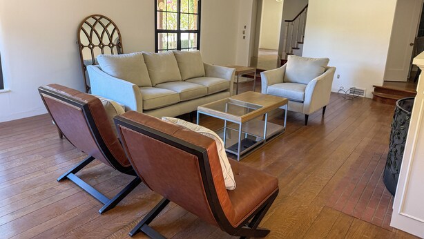 A living room with a sofa, two armchairs, a coffee table, and a staircase leading to another level. - Historic 3-bedroom house on Main st  in charming Sutter Creek (Sutter Creek)