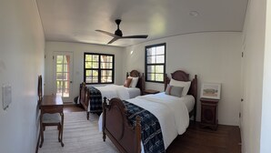 A bedroom with two beds, a ceiling fan, and a window with a view. - Historic 3-bedroom house on Main st  in charming Sutter Creek (Sutter Creek)