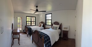 A bedroom with two beds, a ceiling fan, and a window with a view. - Historic 3-bedroom house on Main st  in charming Sutter Creek (Sutter Creek)