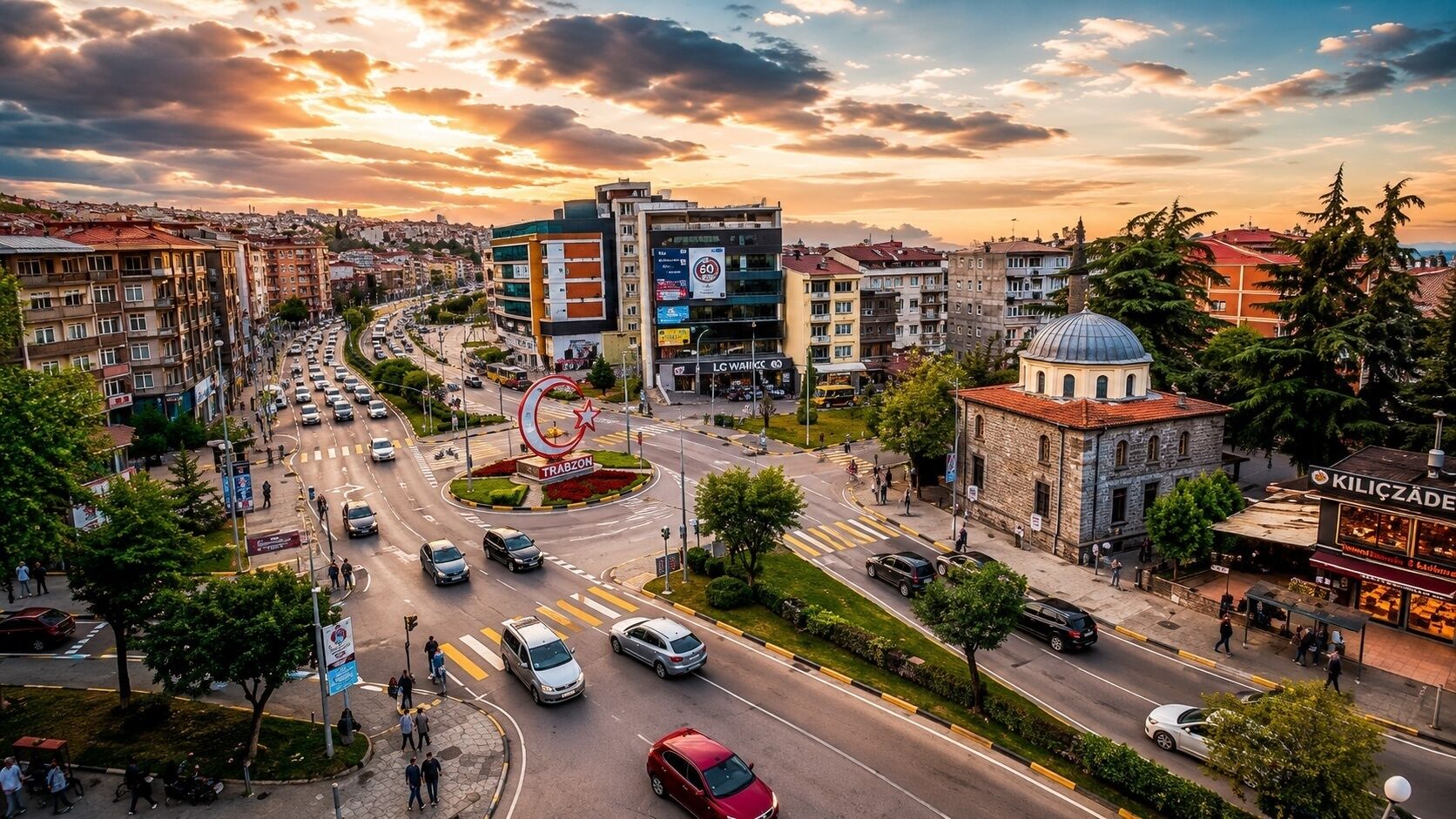 Une vue urbaine comprenant un rond-point, des immeubles et un restaurant.