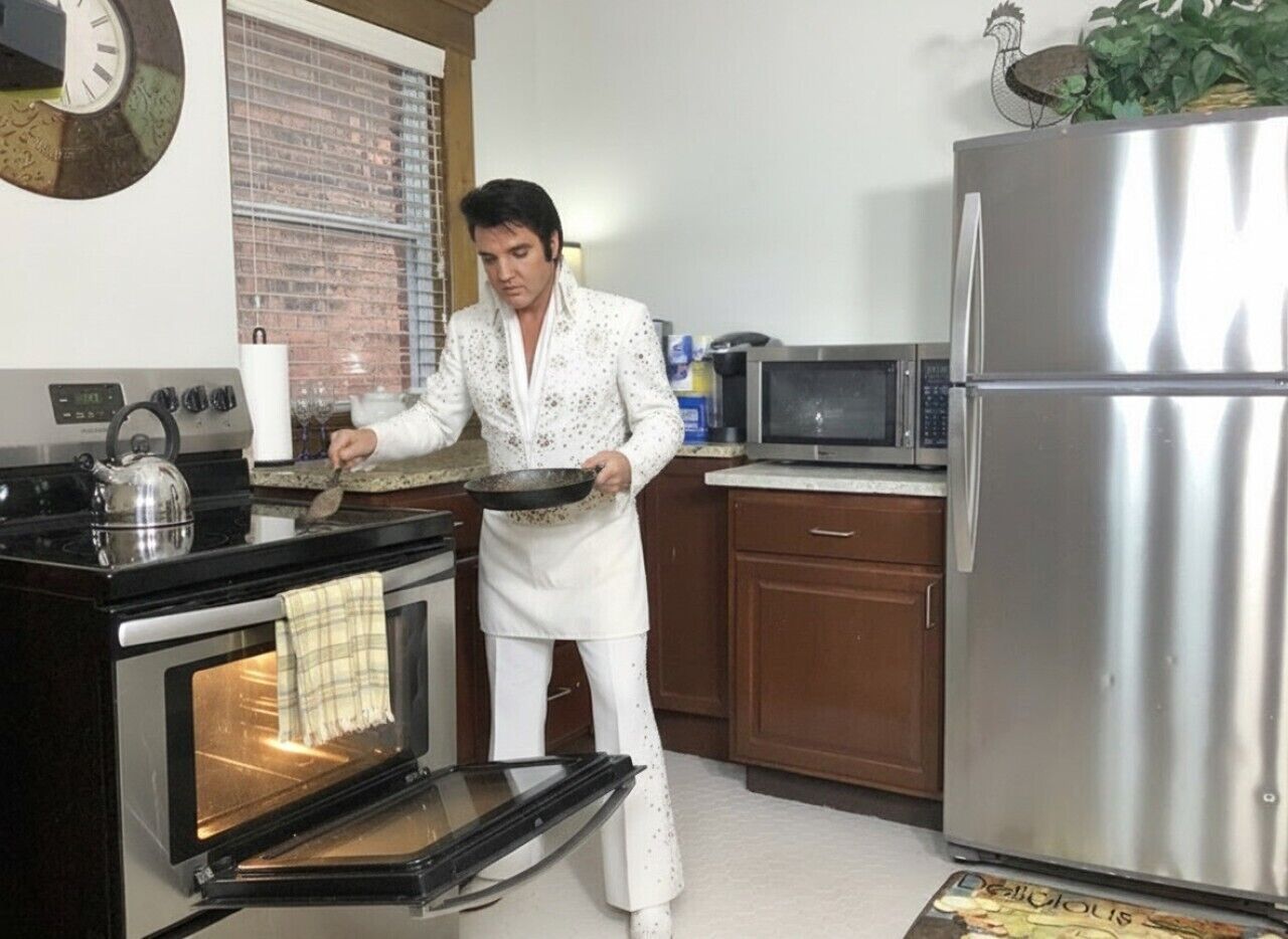 A kitchen with a stove, oven, microwave, and refrigerator.