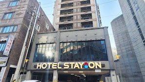 A multi-story building with a sign reading 'HOTEL STAYON' at the entrance. - Cordelia Hotel Geoje (Geoje)
