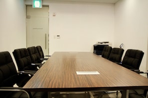 A conference room with a long table, six chairs, a printer, and a door labeled 'Business Room.' - Cordelia Hotel Geoje (Geoje)
