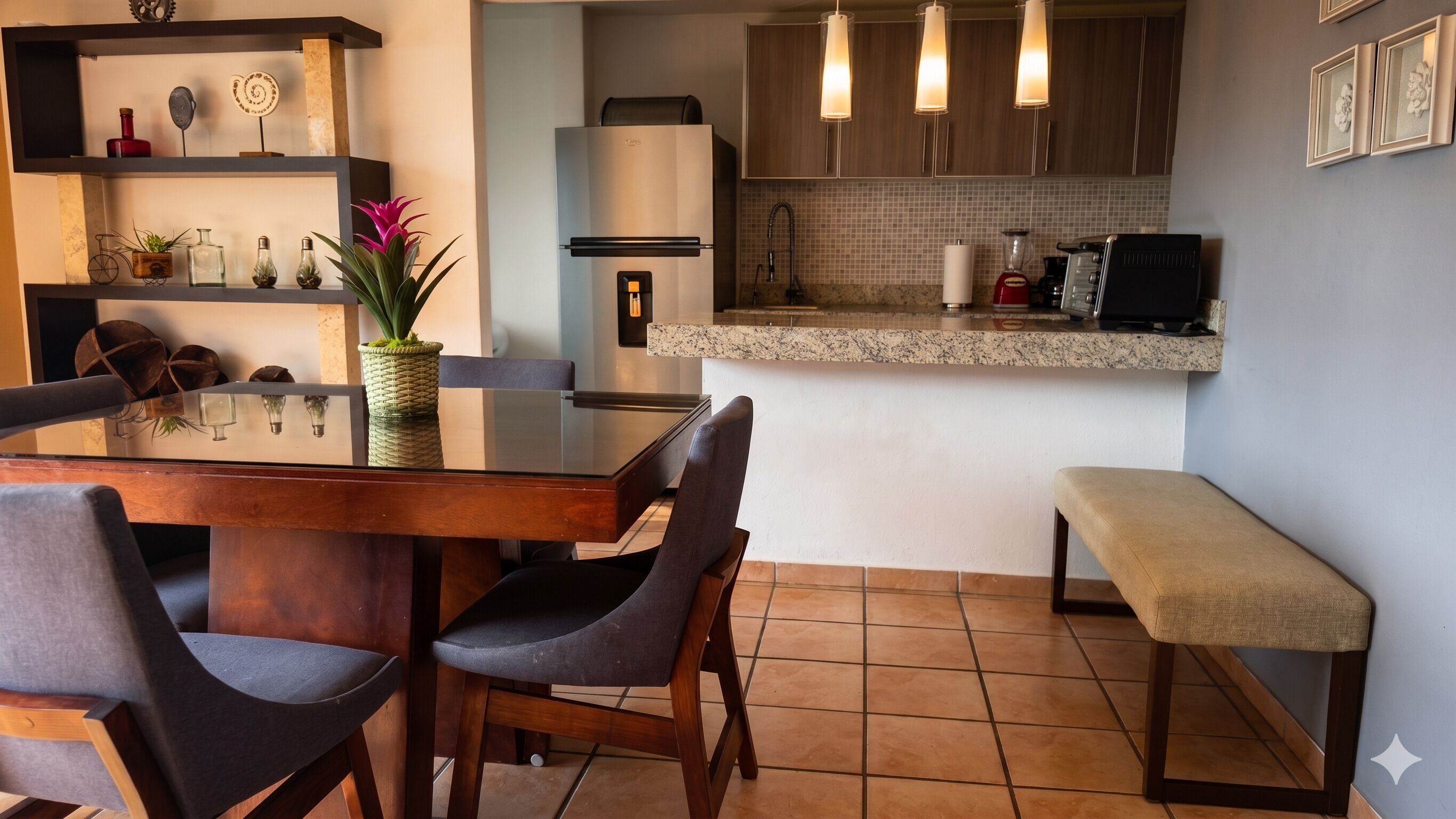 A modern kitchen with a dining table, chairs, a bench, and a refrigerator.