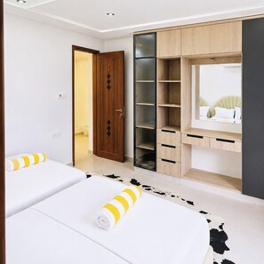 A bedroom with a bed, a wardrobe, and a mirror.