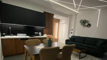 Deluxe appartement, uitzicht op zee | Woonruimte