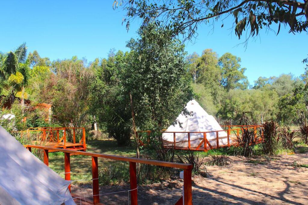 A campsite with tents and a wooden structure.
