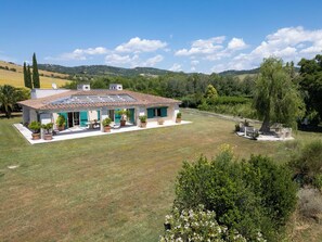 A house with a tiled roof, a covered patio, and a lawn. - La Sorgente by Interhome (Saturnia)