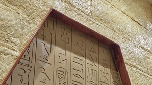 A wooden frame with Egyptian hieroglyphs.