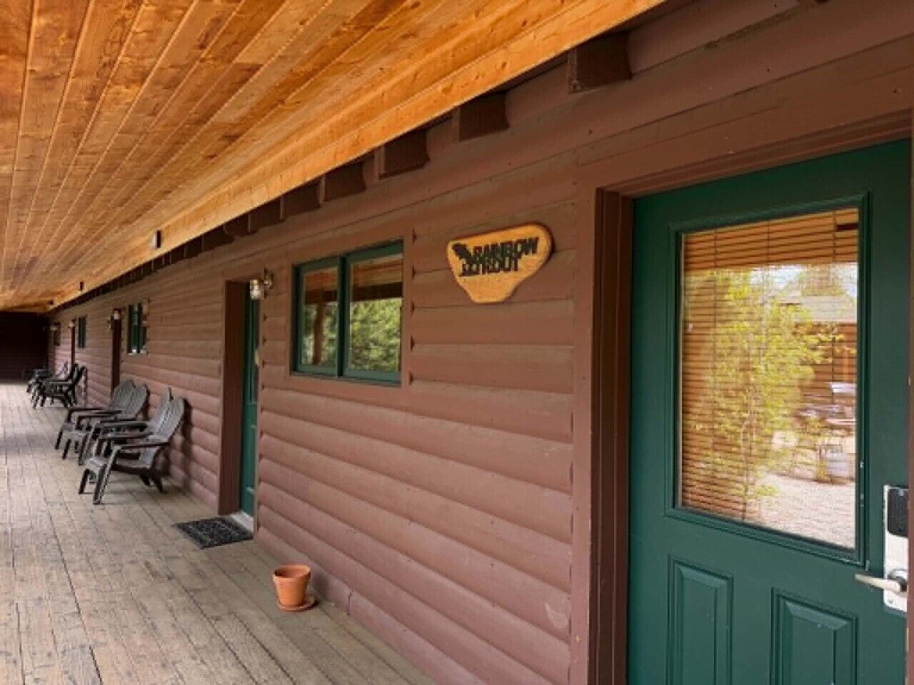 A wooden building with a sign reading 'Rainbow Lodge.'