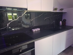 A modern kitchen with a black marble countertop, a built-in oven, and white cabinets. - ★★★★ Villa Bella Vita - Big Private Pool - Tranquility ★★★★ (Duge Njive)