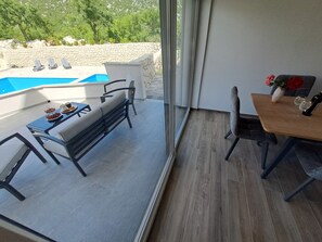 A balcony with a pool, a dining table with chairs, and a view of the outdoors. - ★★★★ Villa Bella Vita - Big Private Pool - Tranquility ★★★★ (Duge Njive)