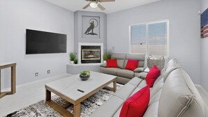 A modern living room with a ceiling fan, a flat-screen TV, a fireplace, a sofa, and a coffee table. - Palomar: New Build, Hot Tub, Pet-Friendly, BBQ (Albuquerque)