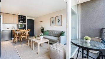 A modern apartment with a kitchen, dining area, and living room.