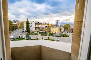 A cityscape with buildings, a road, and a clear sky. - Tbilisi Legend – Rustaveli 37 (T'bilisi)