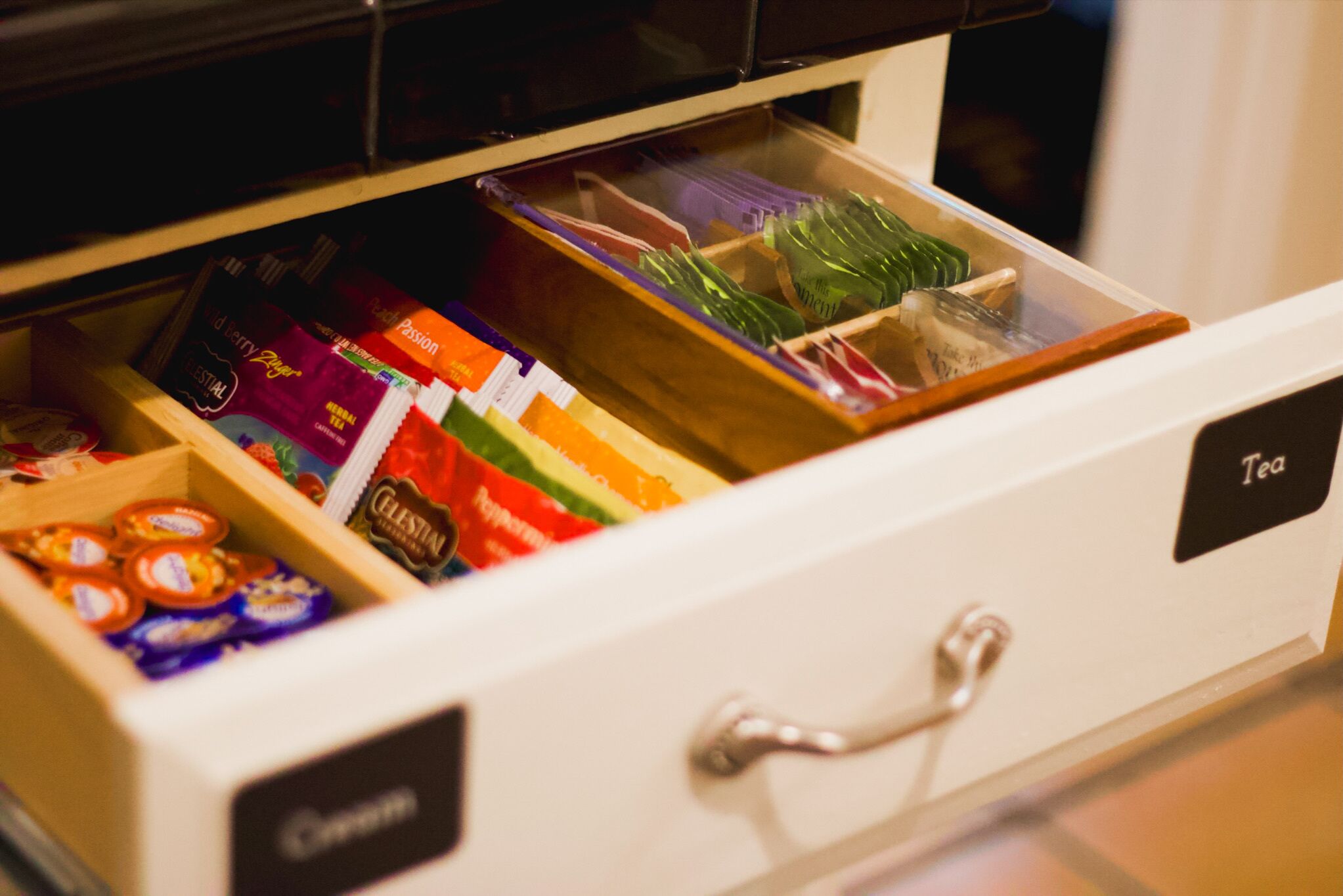 A drawer with compartments containing various packaged items.