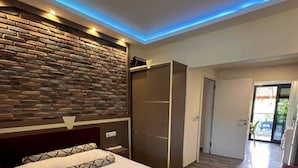 Habitación de hotel con cama, armario, baño y vistas al exterior.